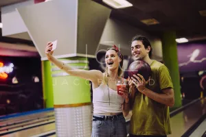 Couple taking selfie at bowling alley